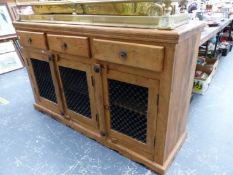 A PINE SIDEBOARD WITH THREE DRAWERS OVER IRON GRILLE PANELLED DOORS