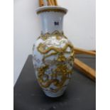 AN ORIENTAL WHITE PORCELAIN VASE DECORATED IN GOLD WIRE WITH DRAGONS AND A PAGODA