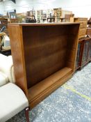 AN OAK OPEN BOOK CASE WITH FOUR FIXED SHELVES