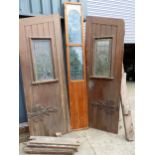 A PAIR OF PITCH PINE DOORS WITH CENTRE PANEL AND FRAME, ALL WITH LEADED GLASS WINDOWS ( FOR