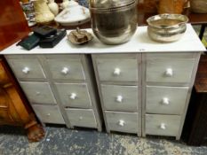 A PAIR OF WHITE PAINTED BEDSIDE CHESTS, EACH WITH TWO BANKS OF THREE DRAWERS