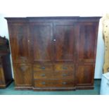 A MAHOGANY BREAKFRONT CABINET, THE CENTRAL DOORS ABOVE TWO SHORT AND TWO LONG DRAWERS ON A PLINTH