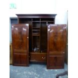 A MAHOGANY TWO DOOR WARDROBE WITH SHELVING, HANGING SPACE AND A LONG DRAWER.