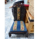 AN ANGLO-INDIAN PIERCED AND CARVED HARD WOOD CHAIR WITH NEEDLEWORK PANEL CENTRAL TO THE BACK AND