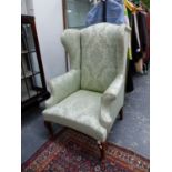 A PALE BLUE DAMASK UPHOLSTERED WING ARMCHAIR