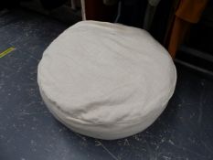 A LARGE HERRINGBONE PATTERN POUFFE.