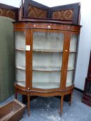 A SATIN WOOD BANDED MAHOGANY DISPLAY CABINET, THE SERPENTINE FRONTED DOOR FLANKED BY QUARTER ROUND