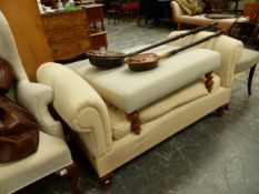 A BROAD WINDOW SEAT ON MAHOGANY LEGS TOGETHER WITH A STOOL THE UPHOLSTERED SEAT ON TURNED PINE LEGS