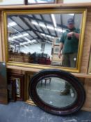 AN EDWARDIAN BEVEL OVAL MIRROR, TOGETHER WITH ANOTHER GILT MIRROR AND A LARGER CONTEMPORARY GILT