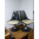 A PAIR OF GREY PLASTIC AND CREAM SEATED CHAIRS SWIVELLING ON ALUMINIUM COLUMNS AND CIRCULAR FEET