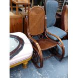 A BENTWOOD ROCKING CHAIR WITH CANED BACK