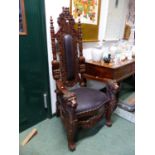 A PAIR OF CARVED MAHOGANY THRONES WITH LEATHER PADDED BACK AND SEATS, THE ARMS WITH LION MASK