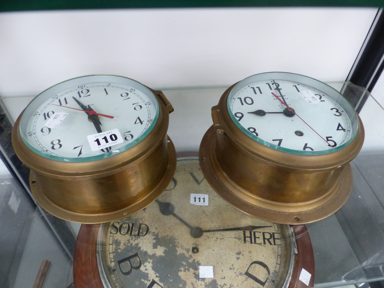 A SMITHS ELECTRIC AND AN ELLIOTT CLOCK WORK SHIPS BRASS CASED WALL CLOCK