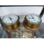 A SMITHS ELECTRIC AND AN ELLIOTT CLOCK WORK SHIPS BRASS CASED WALL CLOCK