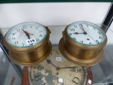 A SMITHS ELECTRIC AND AN ELLIOTT CLOCK WORK SHIPS BRASS CASED WALL CLOCK