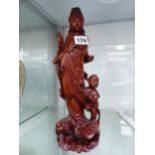 A CHINESE CARVED WOOD FIGURE OF GUANYIN WITH CHILD ATTENDANT