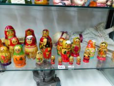 A COLLECTION OF RUSSIAN BABUSHKA DOLLS, ANOTHER DOLL TOGETHER WITH GUIDE BOOKS AND A SMALL