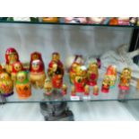 A COLLECTION OF RUSSIAN BABUSHKA DOLLS, ANOTHER DOLL TOGETHER WITH GUIDE BOOKS AND A SMALL