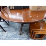 A MAHOGANY BREAKFAST TABLE ON THREE REEDED LEGS WITH BRASS CASTOR FEET