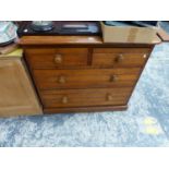 AN OAK CHEST OF TWO SHORT AND TWO LONG DRAWERS EACH WITH KNOB HANDLES