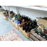 A VERY LARGE COLLECTION OF VINTAGE GLASS AND POTTERY BEER BOTTLES, JUGS, CRATES, AND OTHER BOTTLES