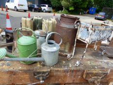 A SMALL MILK CHURN, 3 GALVANISED WATERING CANS AND A RECTANGULAR PLANTER IN A PAINTED WROUGHT IRON