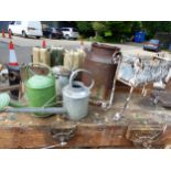 A SMALL MILK CHURN, 3 GALVANISED WATERING CANS AND A RECTANGULAR PLANTER IN A PAINTED WROUGHT IRON