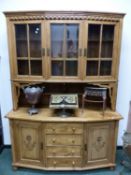 A PINE DISPLAY CABINET, THE UPPER HALF WITH THREE GLAZED DOORS ENCLOSING SHELVES AND RECESSED