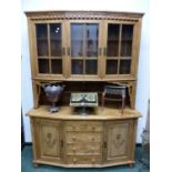 A PINE DISPLAY CABINET, THE UPPER HALF WITH THREE GLAZED DOORS ENCLOSING SHELVES AND RECESSED