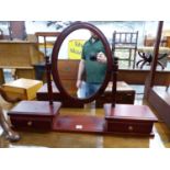AN OVAL DRESSING TABLE MIRROR ON STAINED PINE TWO DRAWER BASE TOGETHER WITH A MAHOGANY DRESSING