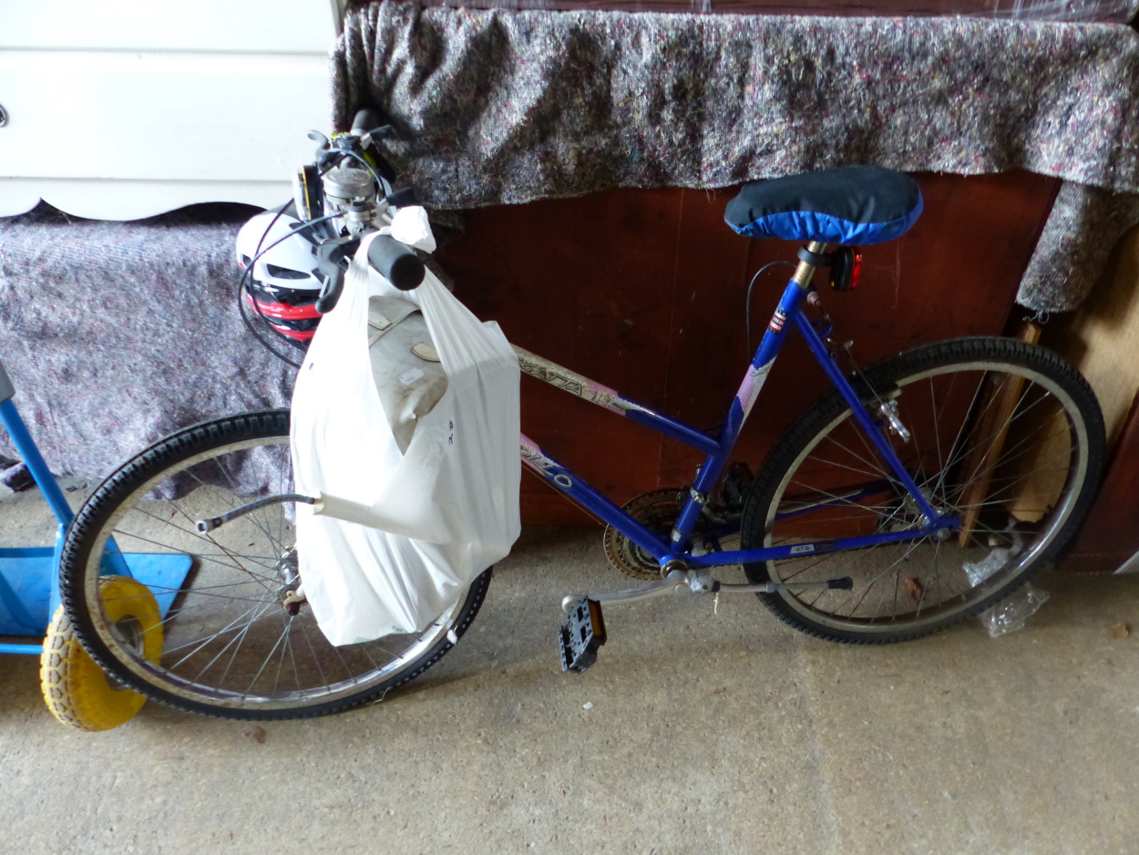 A LADYS MOUNTAIN BIKE WITH NEW HELMET, ETC.