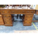 AN OAK NINE DRAWER PEDESTAL DESK