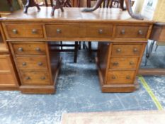 AN OAK NINE DRAWER PEDESTAL DESK