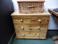 A VICTORIAN STRIPPED PINE SMALL CHEST OF FOUR DRAWERS.