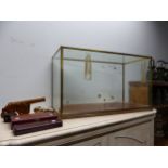 A GLAZED BRASS TABLE TOP DISPLAY CASE, A WOODEN CANNON, TWO CASES OF WINE SERVING IMPLEMENTS AND