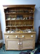 A PINE DRESSER WITH ENCLOSED THREE SHELF BACK. W 141 x D 52 x H 208cms.