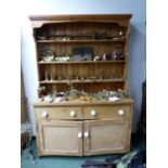 A PINE DRESSER WITH ENCLOSED THREE SHELF BACK. W 141 x D 52 x H 208cms.