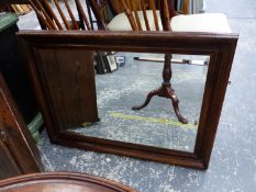 A RECTANGULAR BEVELLED GLASS MIRROR IN AN OAK FRAME