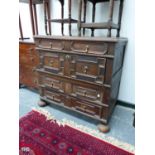 A 17th C. OAK CHEST, THE FOUR DRAWERS EACH WITH GEOMETRICALLY PANELLED FRONTS