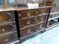 AN OAK CHEST OF THREE LONG DRAWERS EACH WITH GEOMETRICALLY PANELLED FRONTS