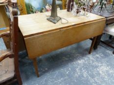 AN OAK DROP FLAP DINING TABLE ON TAPERING SQUARE LEGS