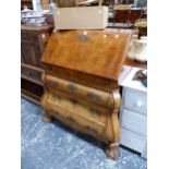 A DUTCH WALNUT BUREAU, THE FALL ABOVE THREE BOMBE DRAWERS AND MASSIVE BALL AND CLAW FEET