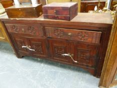 A STAINED PINE SIDE CABINET WITH TWO ROUNDEL CARVED DRAWERS OVER PAIRS OF CUPBOARD DOORS