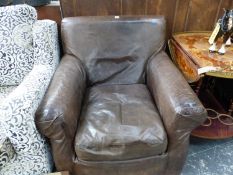 A BROWN LEATHER UPHOLSTERED ARMCHAIR