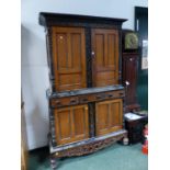 A DUTCH HARDWOOD AND EBONY SIDE CABINET WITH CUPBOARDS ABOVE AND BELOW THREE CENTRAL DRAWERS. W