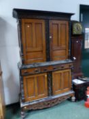 A DUTCH HARDWOOD AND EBONY SIDE CABINET WITH CUPBOARDS ABOVE AND BELOW THREE CENTRAL DRAWERS. W