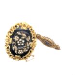 A VICTORIAN LARGE BLACK ENAMEL AND SEED PEARL MOURNING BROOCH. THE GLAZED BACK WITH RED VELVET