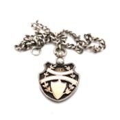 AN EARLY 20th CENTURY SILVER HALLMARKED WITH GOLD OVERLAY SHIELD FORM FOB PENDANT SUSPENDED ON A