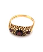 A 9ct YELLOW GOLD HALLMARKED ALMANDINE GARNET AND CUBIC ZIRCONIA CARVED HALF HOOP RING. FINGER