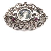 AN ANTIQUE HAND PAINTED MINIATURE AND PASTE SET SILVER BROOCH. THE UNSIGNED PORTRAIT HAND PAINTED IN